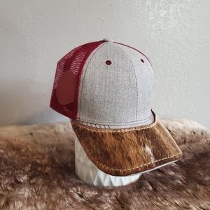 Ball cap with hand-sewn patch on brim